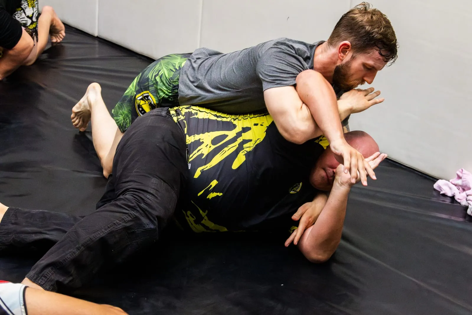 BJJ students practicing ground techniques