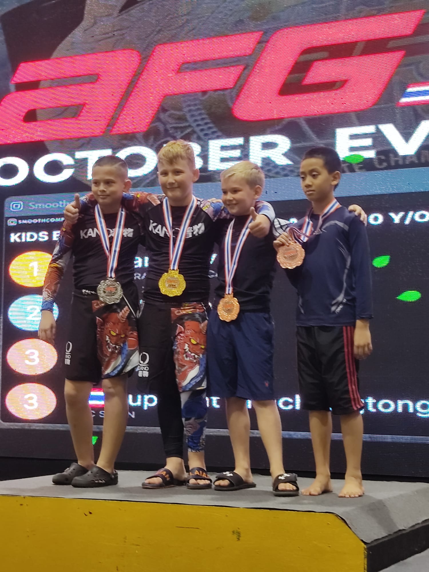 Competing children at medal stand