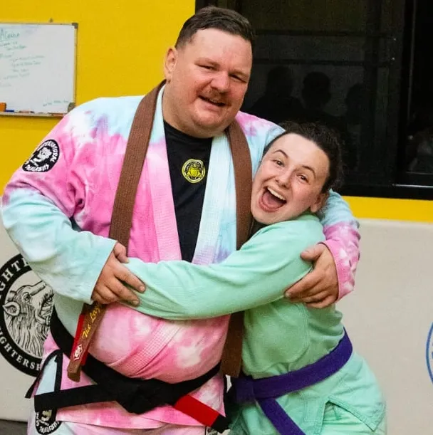 Greg and Rae, owners of Lazy Leopard BJJ Chiang Mai, celebrating after his black belt promotion